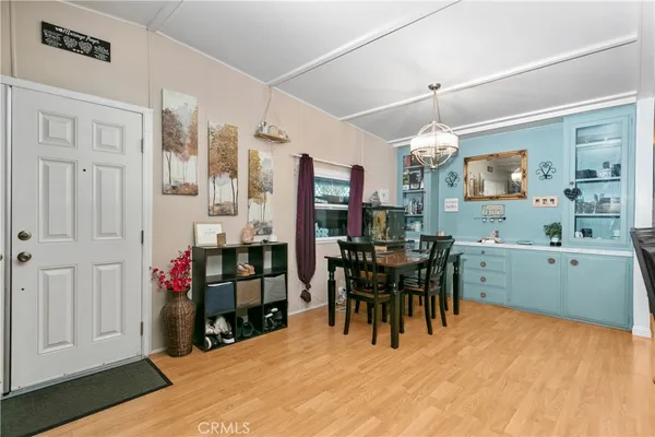 a view of a dining room with furniture and chandelier