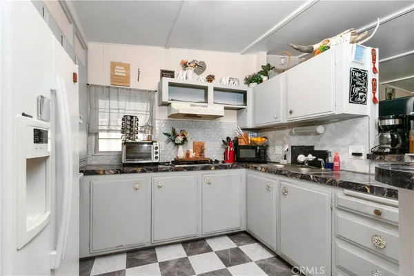 a kitchen with stainless steel appliances granite countertop a sink a stove and cabinets