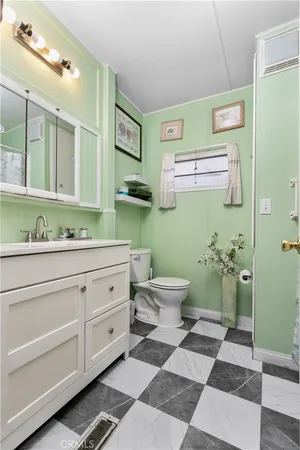 a bathroom with a sink mirror and toilet