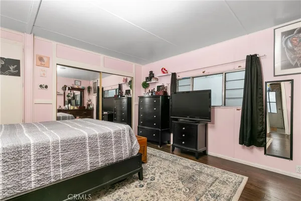 a bedroom with a bed and a flat screen tv