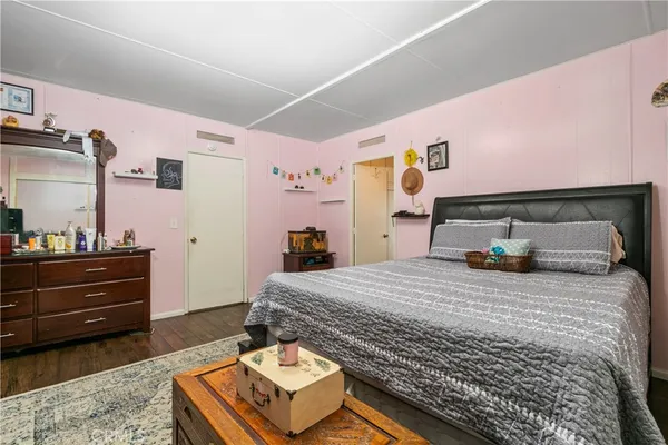 a bedroom with a bed and a dresser