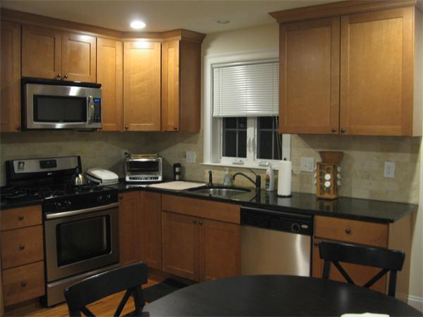 a kitchen with a sink a stove and cabinets