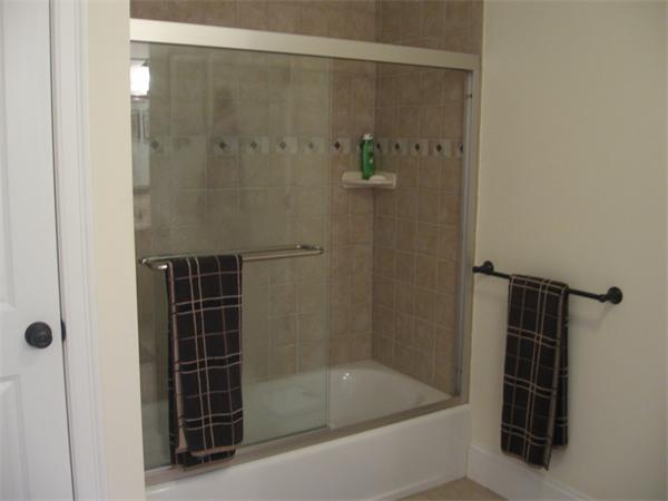 223 Robbins Street, Unit 1 Waltham, MA 02453 - Photo 9 of 12 a bathroom with a shower and a sink