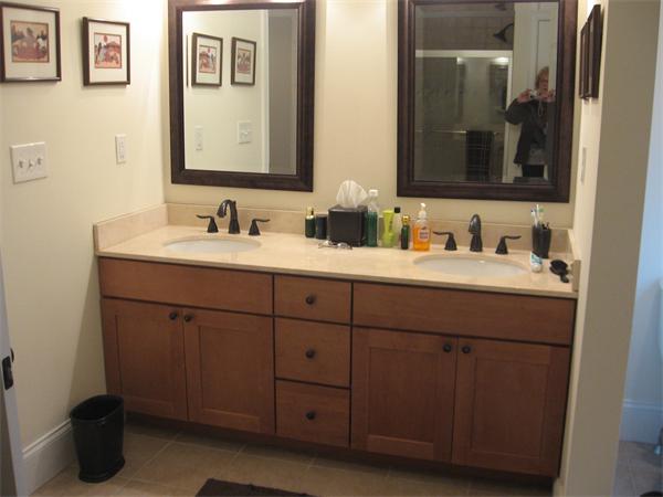 223 Robbins Street, Unit 1 Waltham, MA 02453 - Photo 10 of 12 a bathroom with a double vanity sink and a mirror