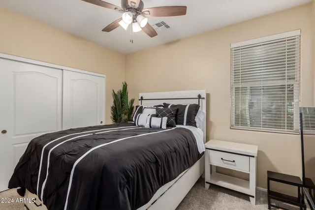 a bedroom with a bed and a tv