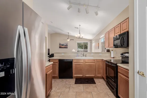 a kitchen with stainless steel appliances granite countertop a refrigerator and a sink