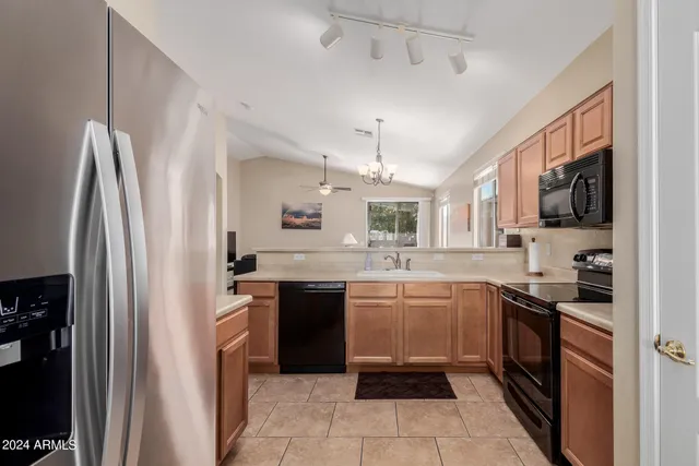 a kitchen with stainless steel appliances granite countertop a refrigerator and a sink
