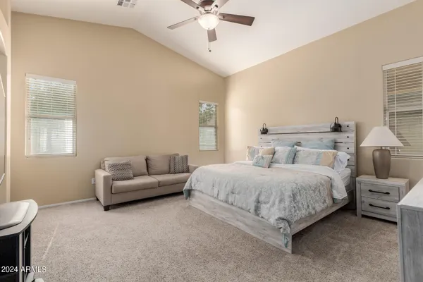 a spacious bedroom with a bed and a couch