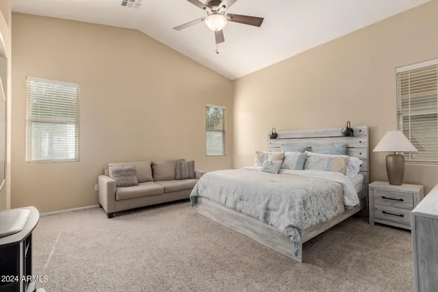 a spacious bedroom with a bed and a couch