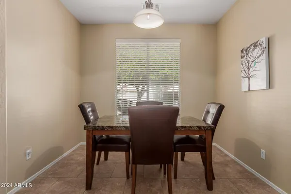 a view of a dining room with furniture and a window