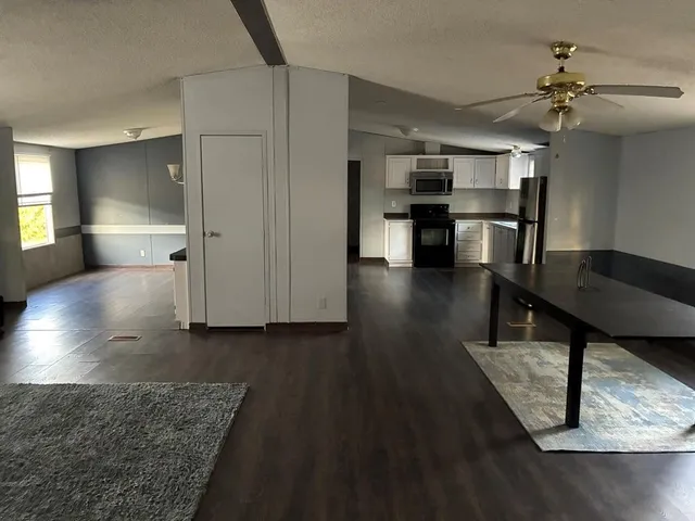 a view of a kitchen with wooden floor and a kitchen