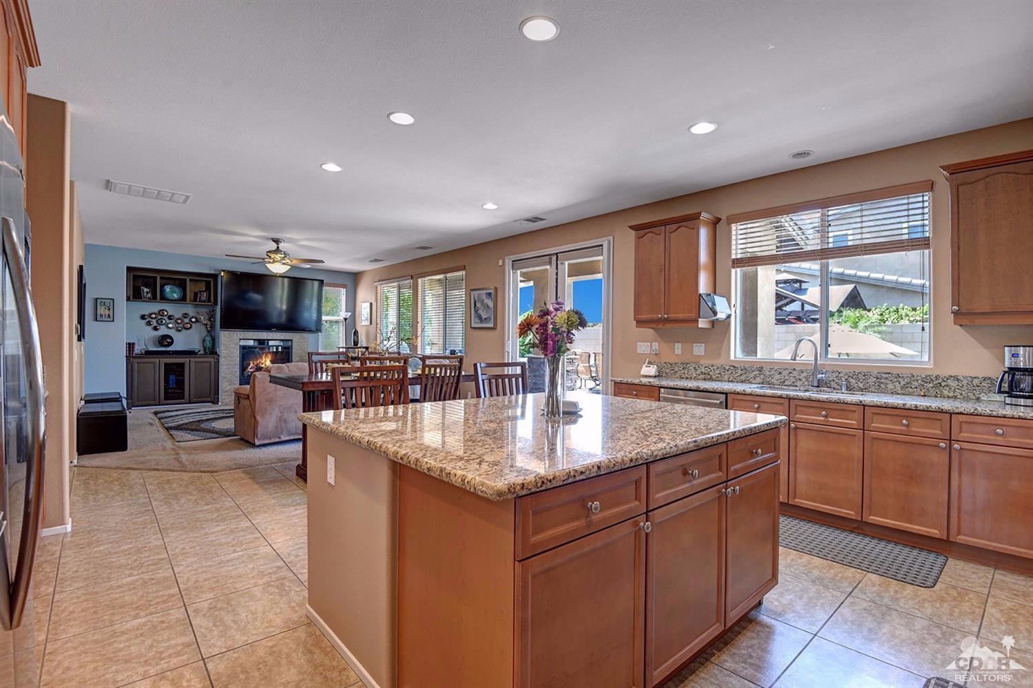 83447 Lone Star Road Indio, CA 92203 - Photo 13 of 47 a kitchen with stainless steel appliances granite countertop a sink counter space cabinets and a large window