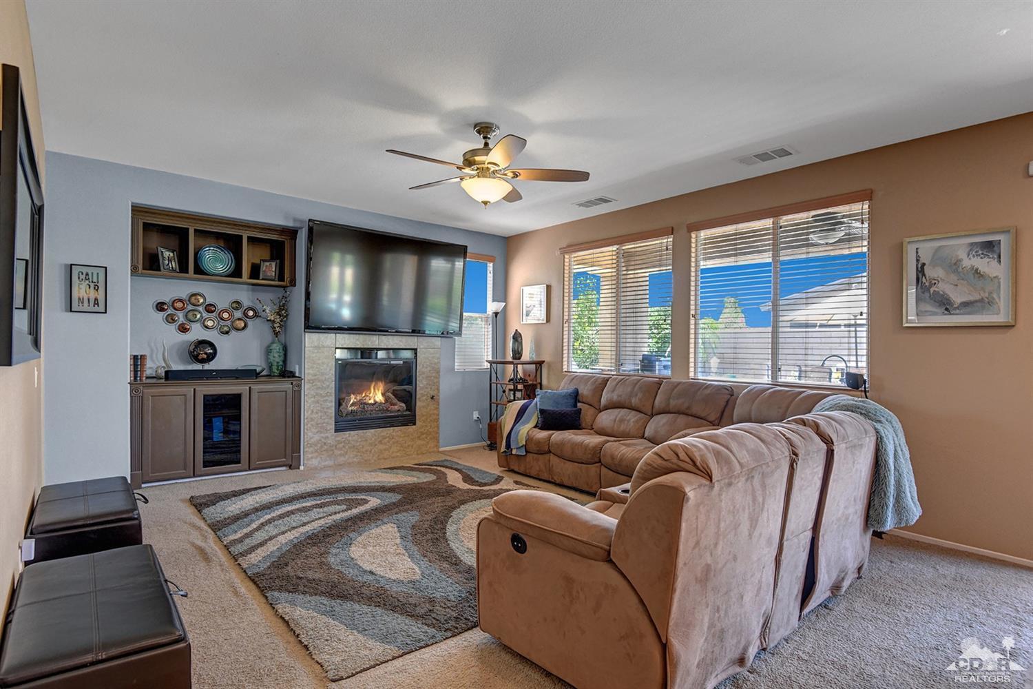 83447 Lone Star Road Indio, CA 92203 - Photo 14 of 47 a living room with furniture a fireplace and a flat screen tv