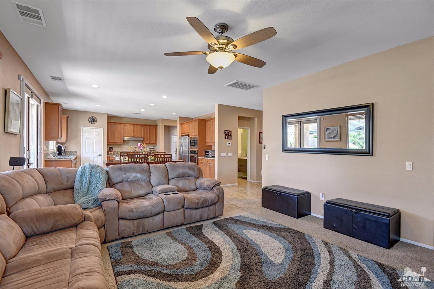 83447 Lone Star Road Indio, CA 92203 - Photo 16 of 47 a living room with furniture ceiling fan and a rug