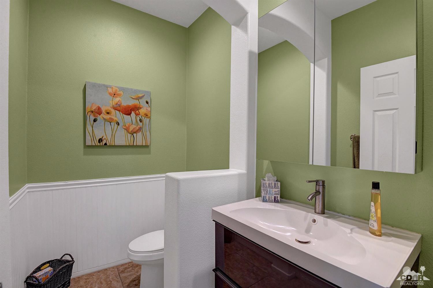 83447 Lone Star Road Indio, CA 92203 - Photo 18 of 47 a bathroom with a sink mirror vanity and toilet