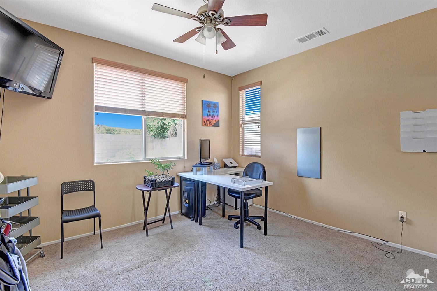 83447 Lone Star Road Indio, CA 92203 - Photo 22 of 47 a view of a workspace with furniture and a window