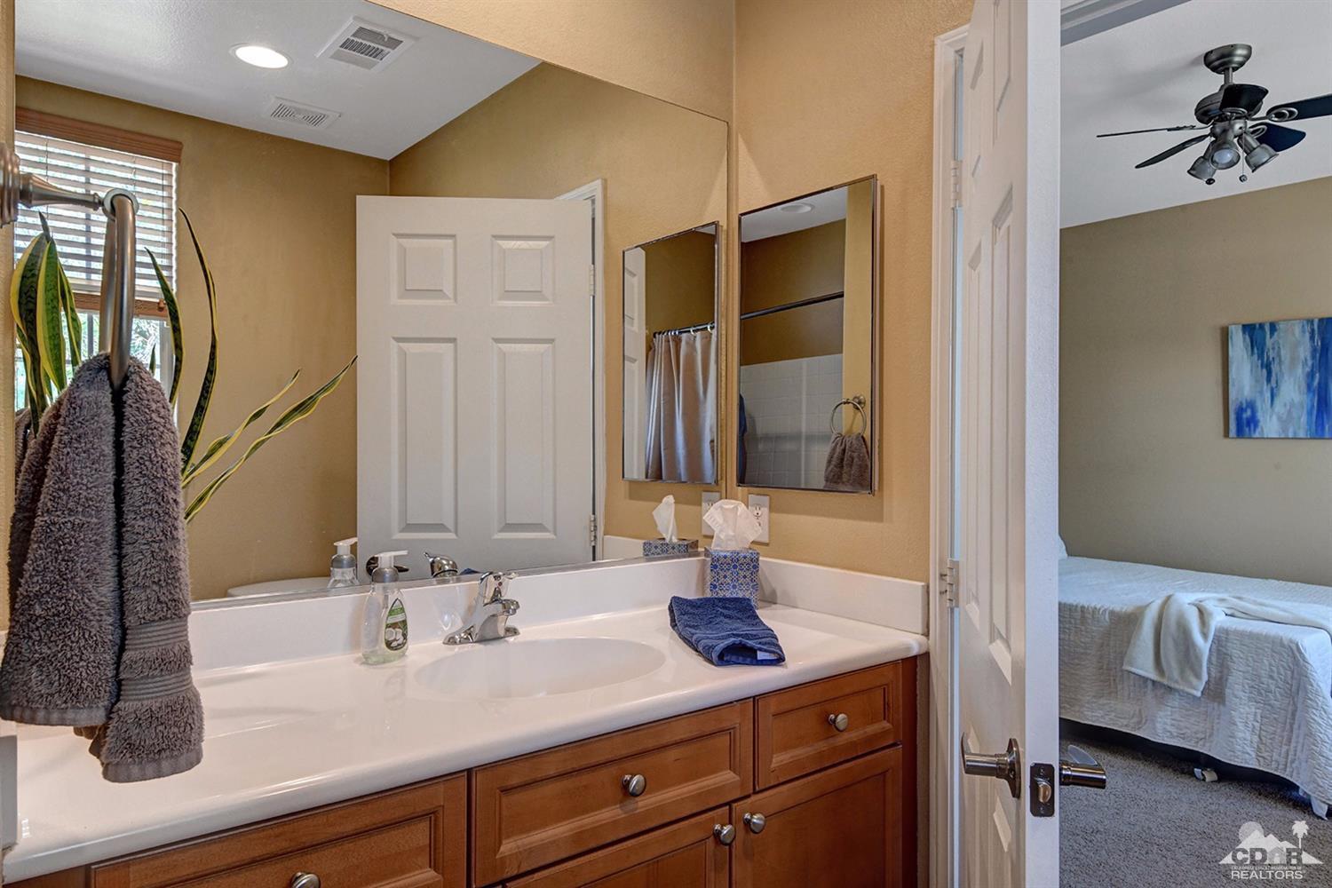 83447 Lone Star Road Indio, CA 92203 - Photo 24 of 47 a en suite bathroom with a double vanity sink and a mirror