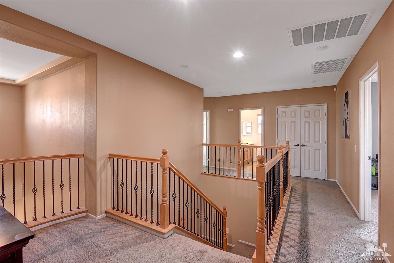 83447 Lone Star Road Indio, CA 92203 - Photo 25 of 47 a view of a hallway with windows and stairs