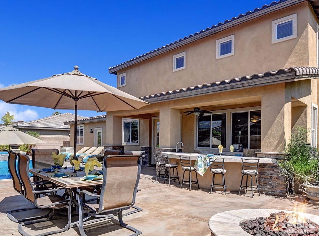 83447 Lone Star Road Indio, CA 92203 - Photo 4 of 47 a patio with a table and chairs under an umbrella
