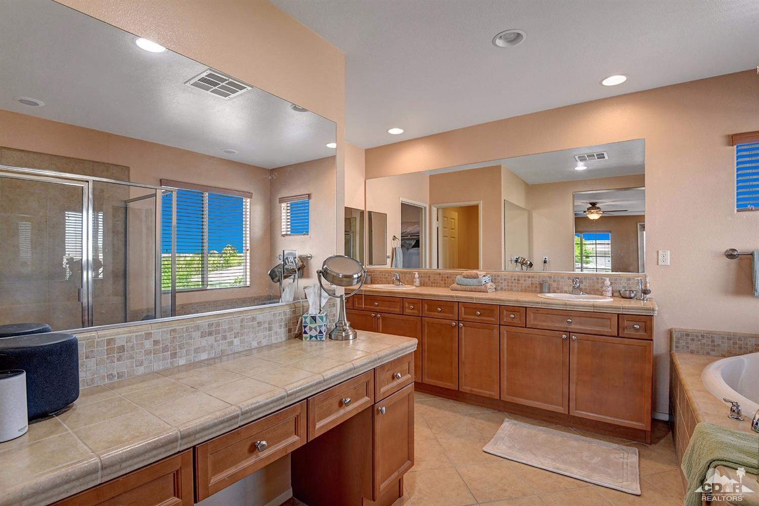 83447 Lone Star Road Indio, CA 92203 - Photo 31 of 47 a large kitchen with kitchen island a sink stainless steel appliances and cabinets