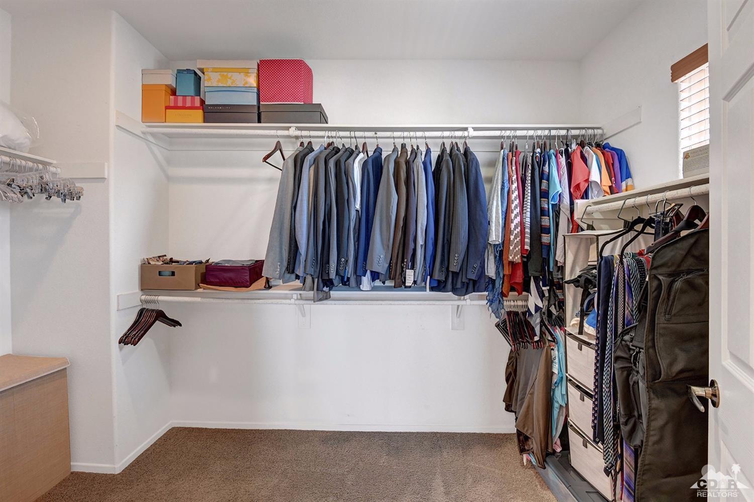 83447 Lone Star Road Indio, CA 92203 - Photo 34 of 47 a view of walk in closet with clothes