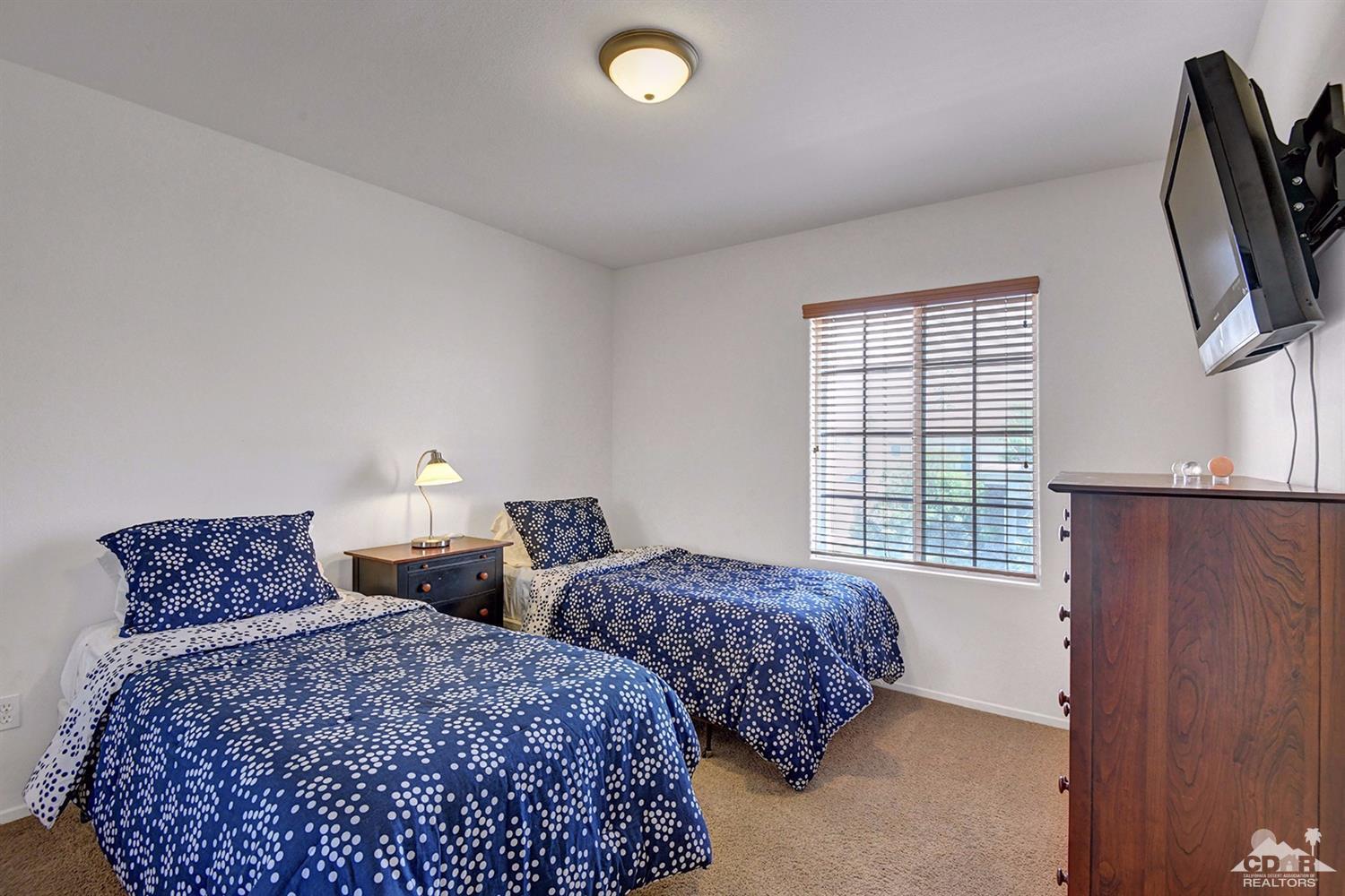 83447 Lone Star Road Indio, CA 92203 - Photo 35 of 47 a bedroom with two beds and a window