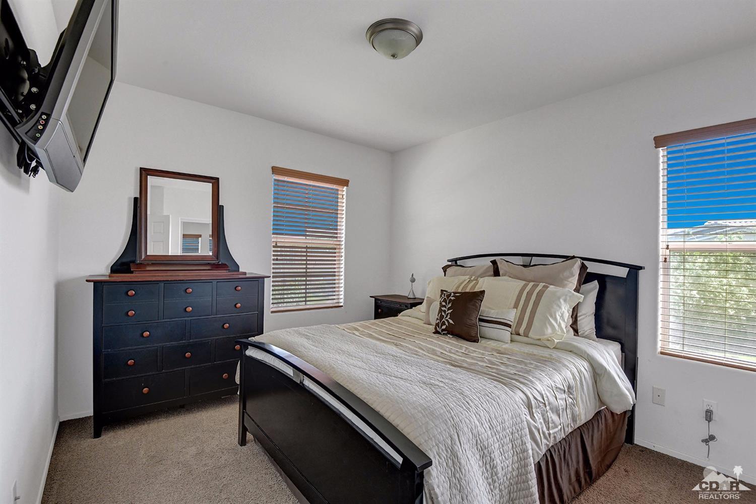 83447 Lone Star Road Indio, CA 92203 - Photo 38 of 47 a bedroom with a bed and a window