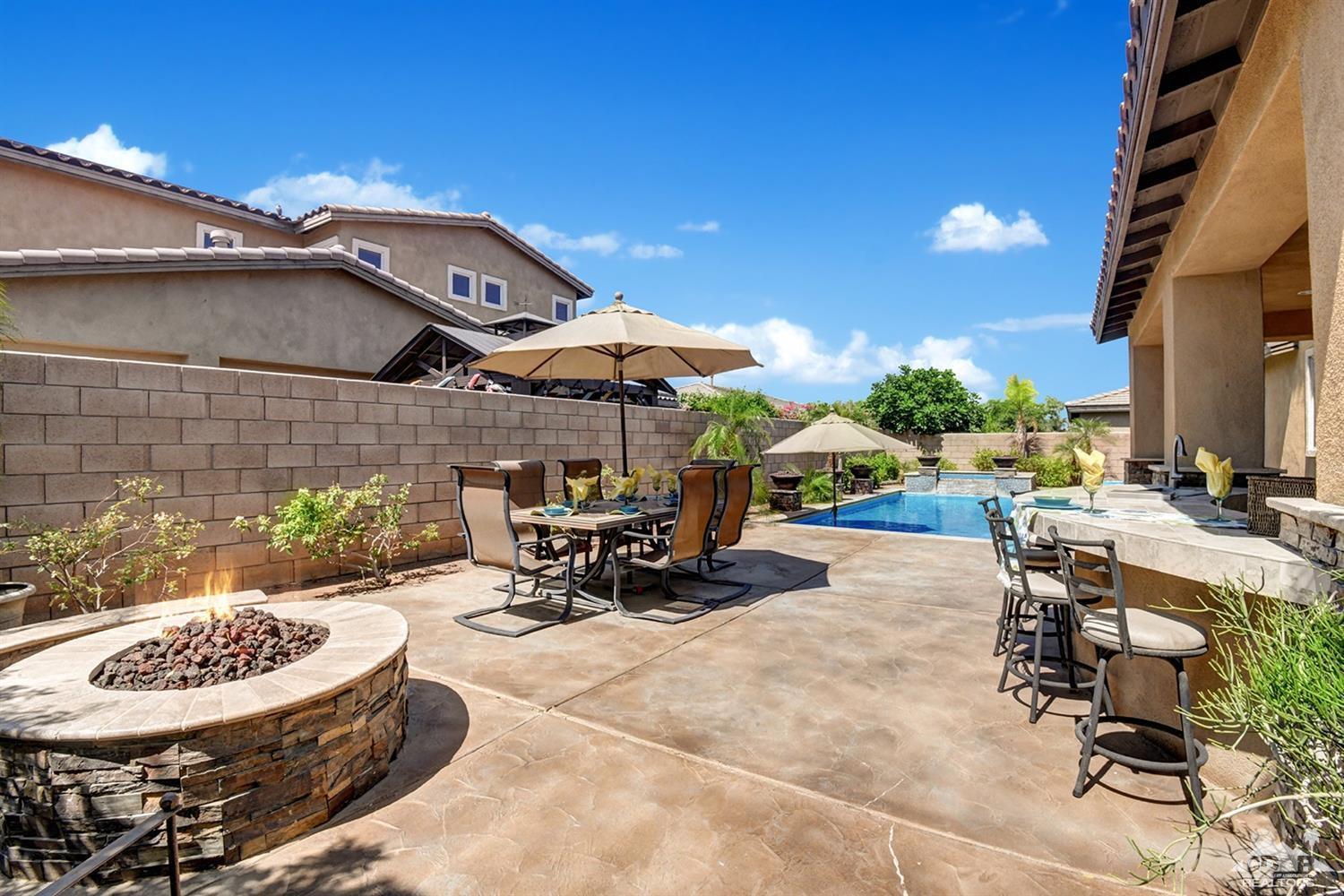 83447 Lone Star Road Indio, CA 92203 - Photo 43 of 47 a view of a patio with a table and chairs under an umbrella