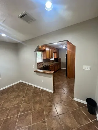 a kitchen with granite countertop a stove a sink and a microwave