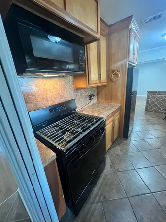 a kitchen with a stove and a microwave