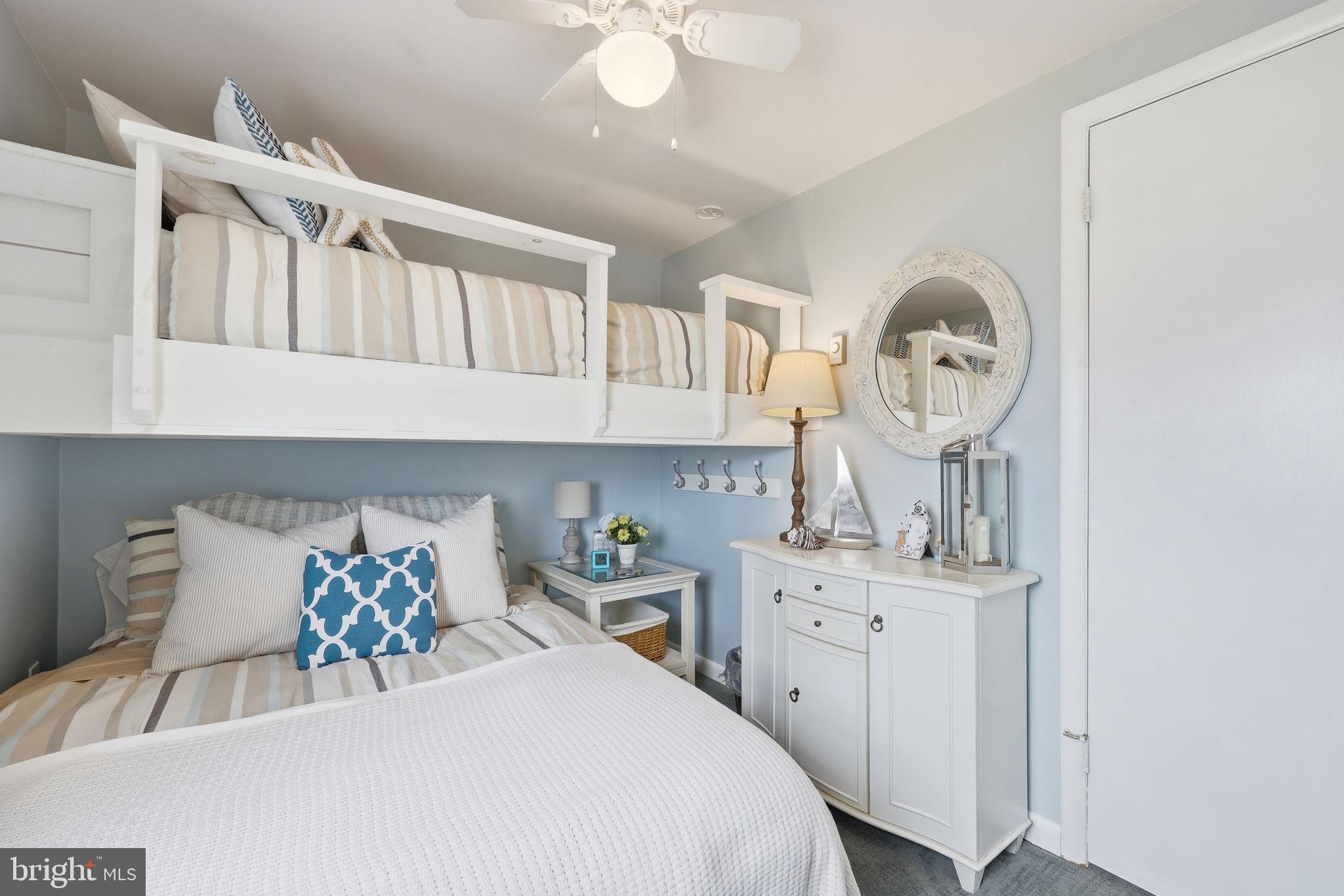 173 Cove Road Newport, NJ 08345 - Photo 30 of 72 a bedroom with a bed a mirror and a table in it