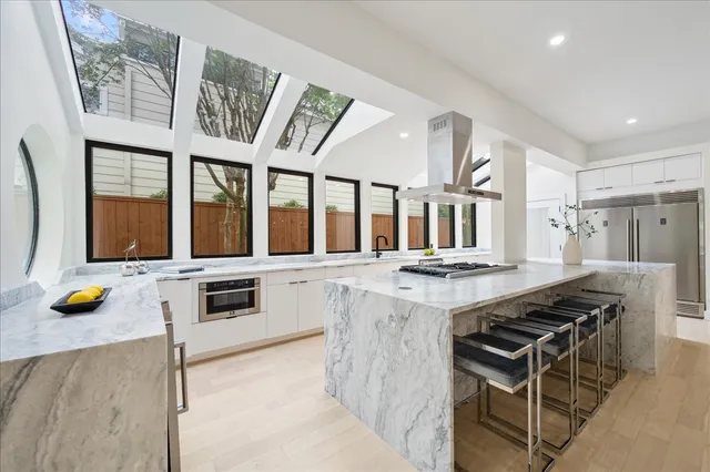 a view of a kitchen with a sink and large cabinets
