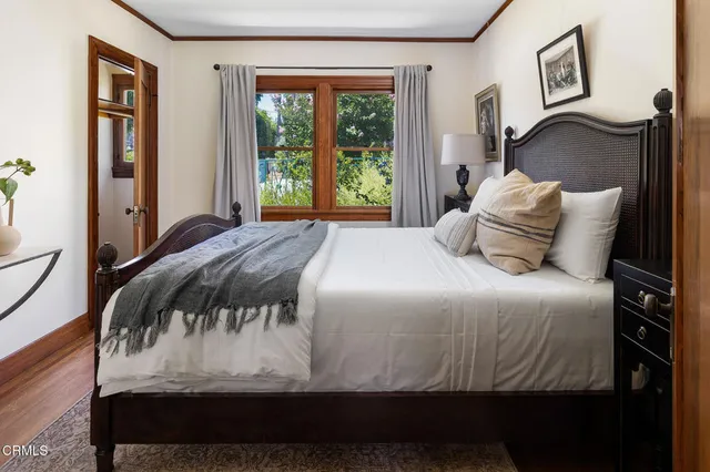 a bedroom with a bed and wooden floor