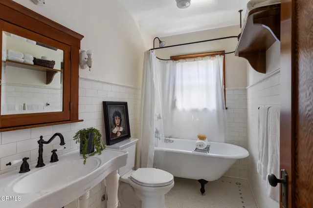 a bathroom with a sink toilet a mirror and shower