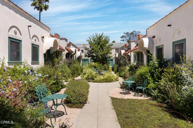 a view of a white apartments with large windows
