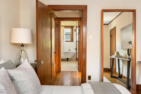 a bedroom with a bed and a large window with outer view