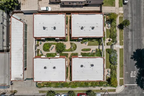 an aerial view of residential houses with outdoor space