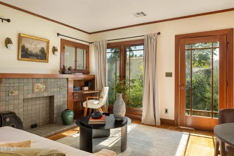 a living room with furniture a window and a fireplace