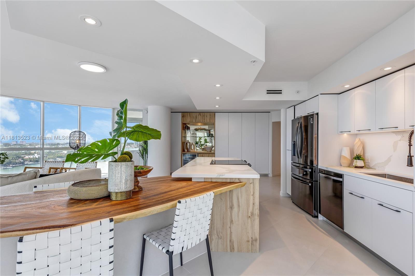 6301 Collins Avenue, Unit 1405 Miami Beach, FL 33141 - Photo 12 of 34 a kitchen with a table and chairs