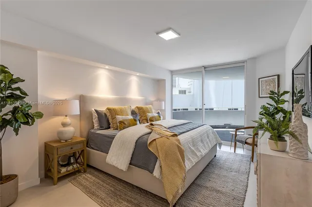 a spacious bedroom with a bed and a potted plant