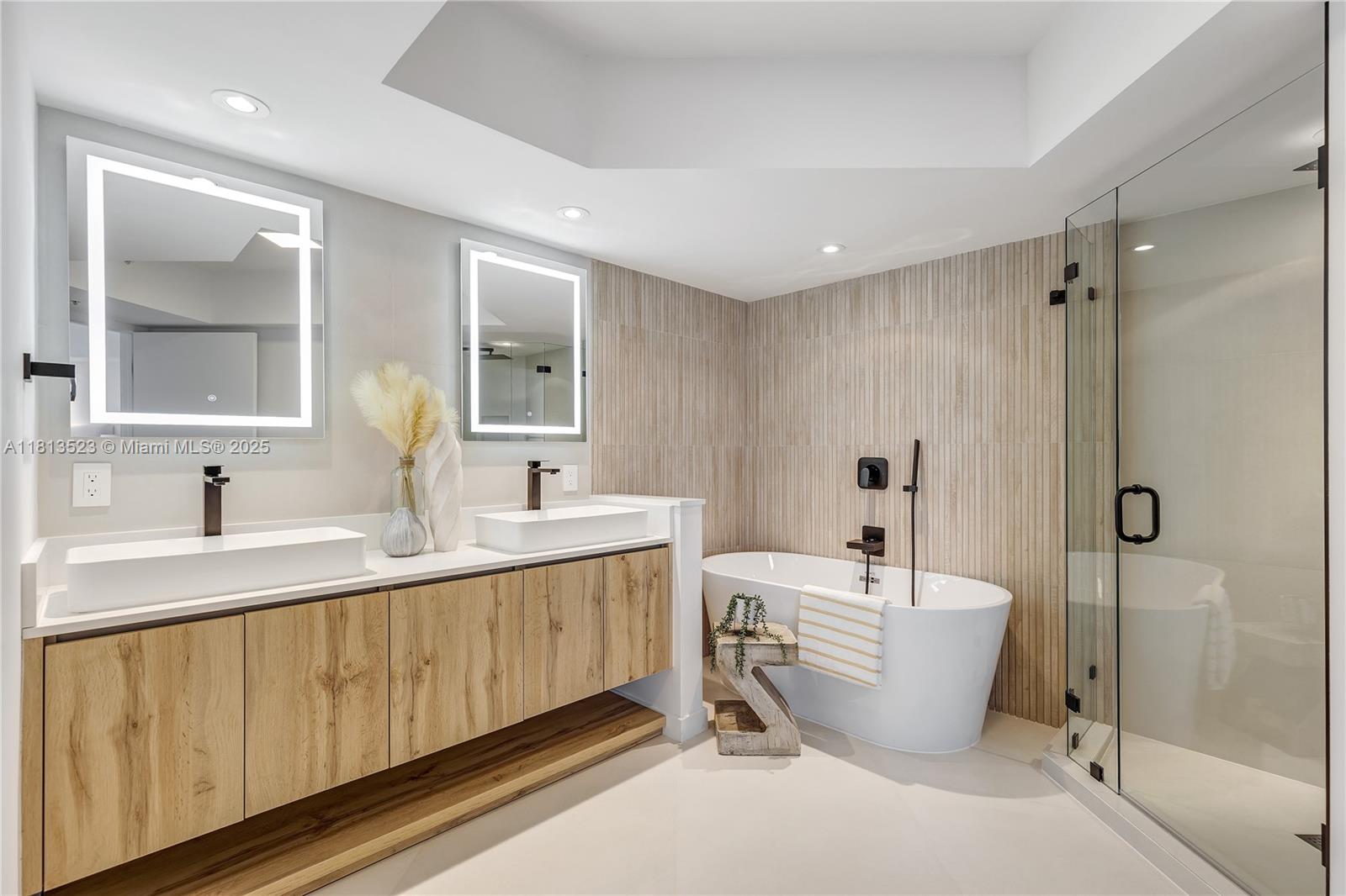 6301 Collins Avenue, Unit 1405 Miami Beach, FL 33141 - Photo 17 of 34 a large spacious bathroom with a double vanity sink a mirror and a bathtub