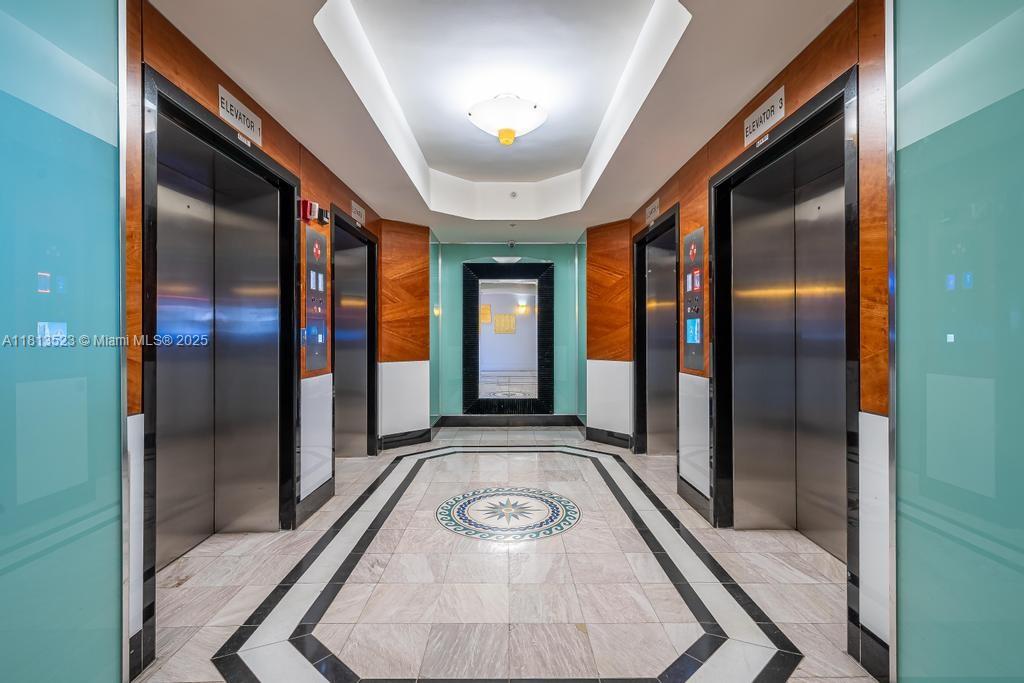 6301 Collins Avenue, Unit 1405 Miami Beach, FL 33141 - Photo 26 of 34 a view of a hallway with wooden floor and staircase