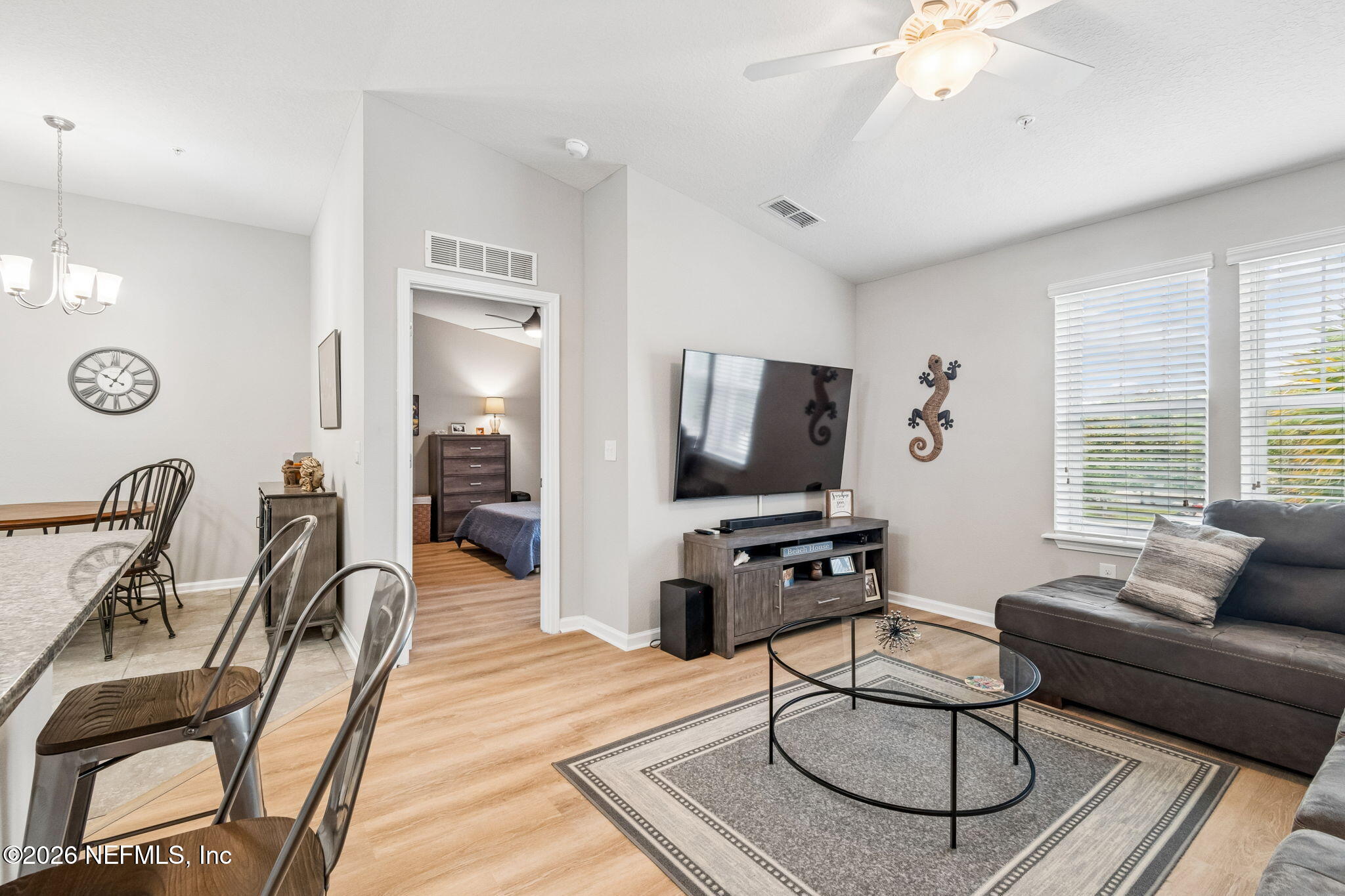2113 Golden Lake Loop St. Augustine, FL 32084 - Photo 11 of 50 a living room with furniture a flat screen tv and kitchen view