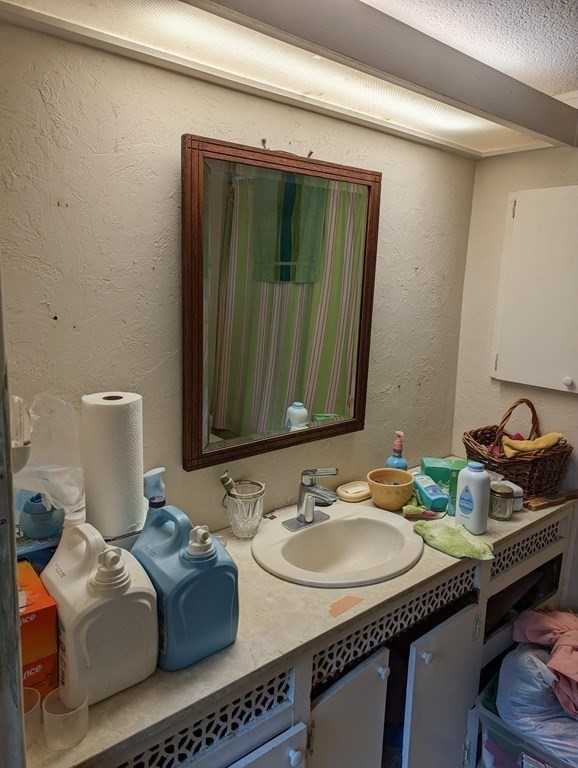 16 King Drive Wareham, MA 02576 - Photo 13 of 17 a bathroom with a granite countertop sink and a mirror