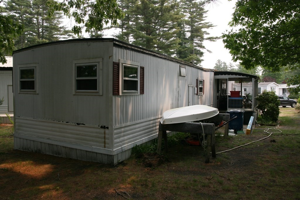 16 King Drive Wareham, MA 02576 - Photo 3 of 17 a backyard of a house with table and chairs
