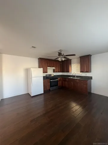 a kitchen with kitchen island wooden cabinets and stainless steel appliances