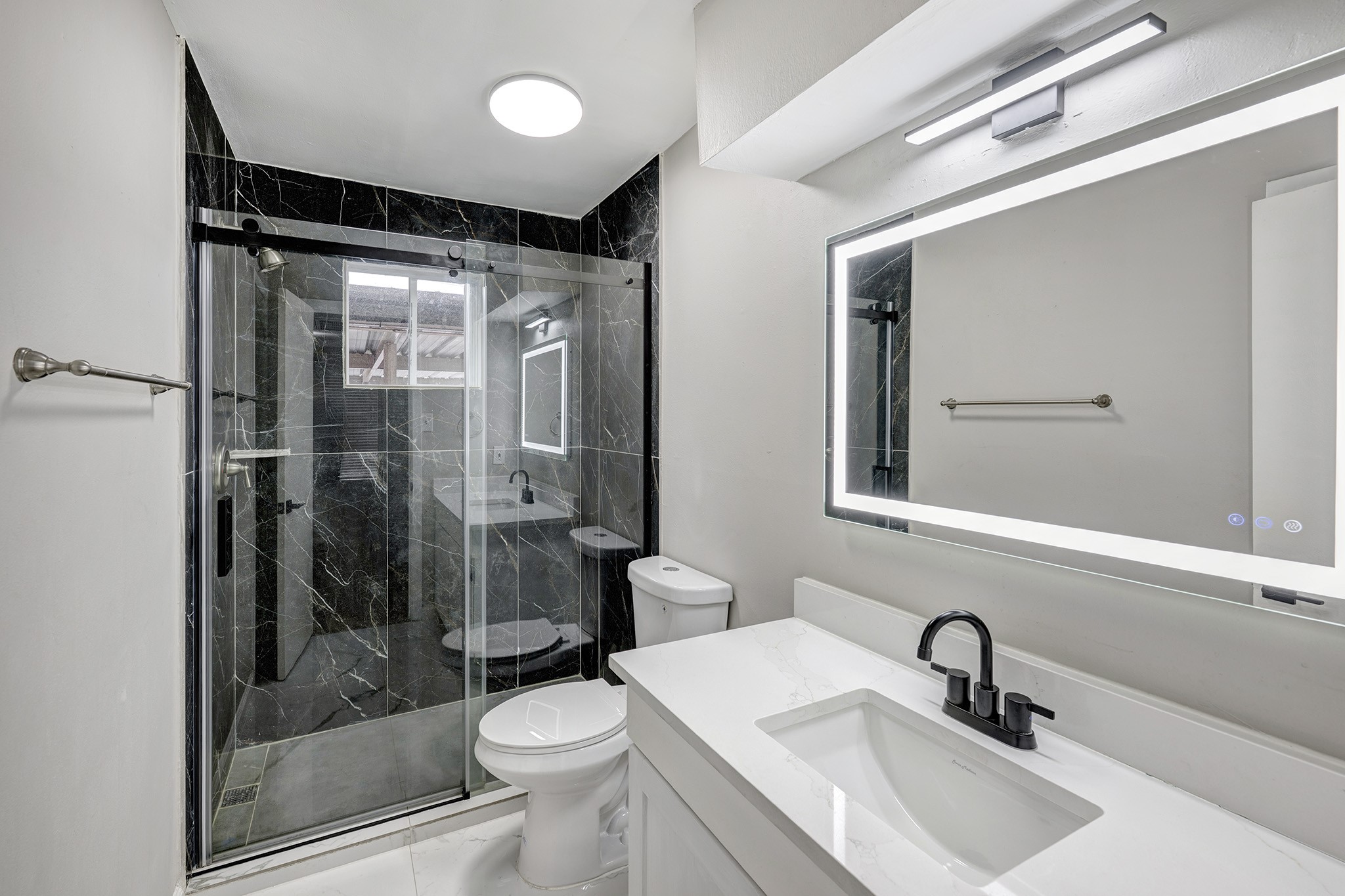 1529 Wirt Road, Unit 20 Houston, TX 77055 - Photo 9 of 12 a bathroom with a sink shower and a toilet