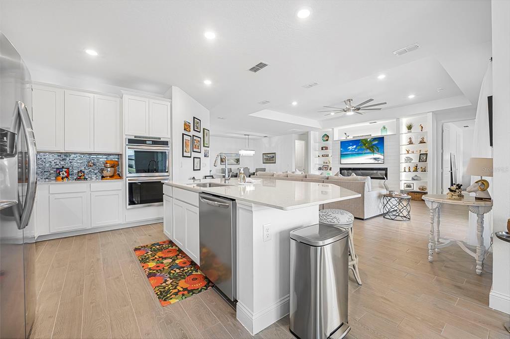 2128 Raglan Circle Ormond Beach, FL 32174 - Photo 11 of 55 a kitchen with stainless steel appliances kitchen island granite countertop a sink and cabinets