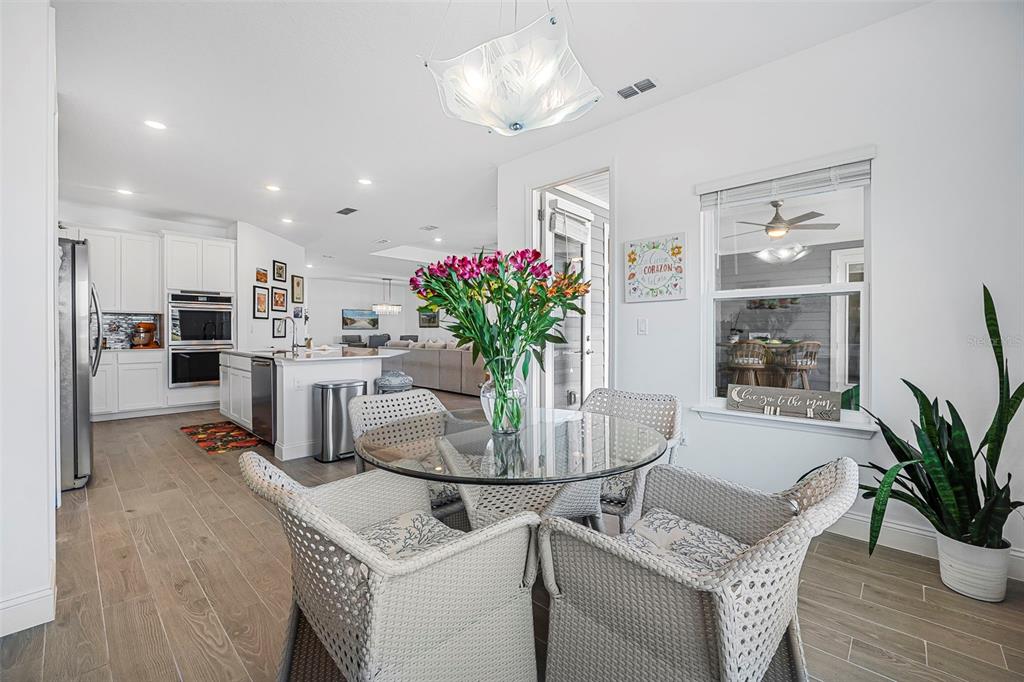 2128 Raglan Circle Ormond Beach, FL 32174 - Photo 14 of 55 a dining room with furniture and potted plant