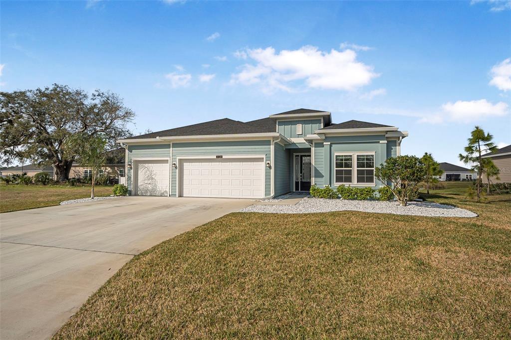 2128 Raglan Circle Ormond Beach, FL 32174 - Photo 2 of 55 a front view of a house with a garden